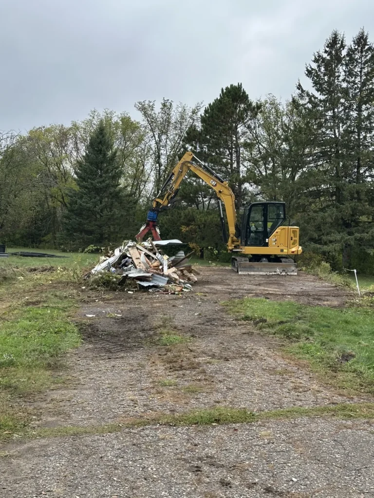 Excavator at a work area with demolition debris